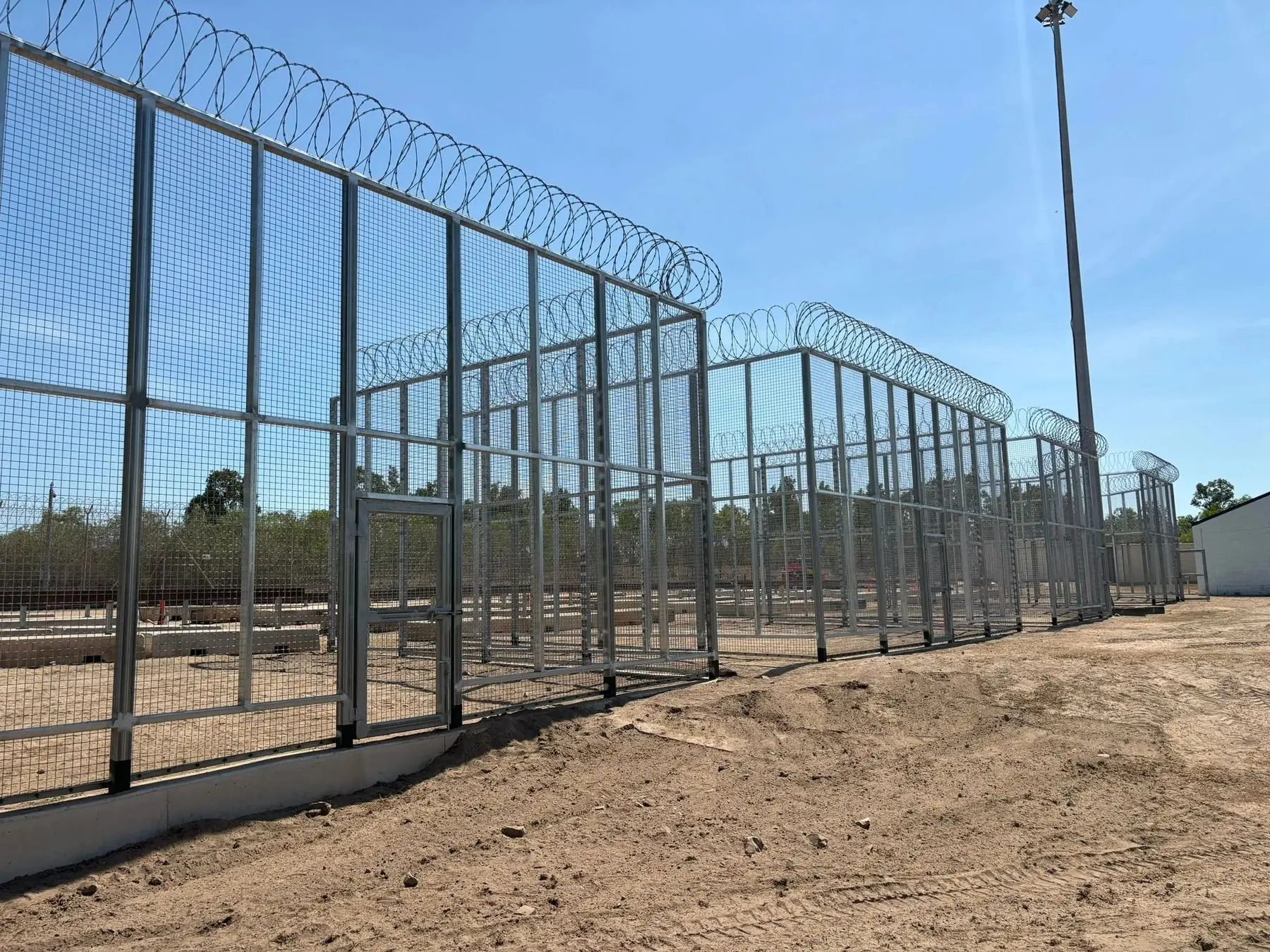 Steel mesh enclosure with razor wire